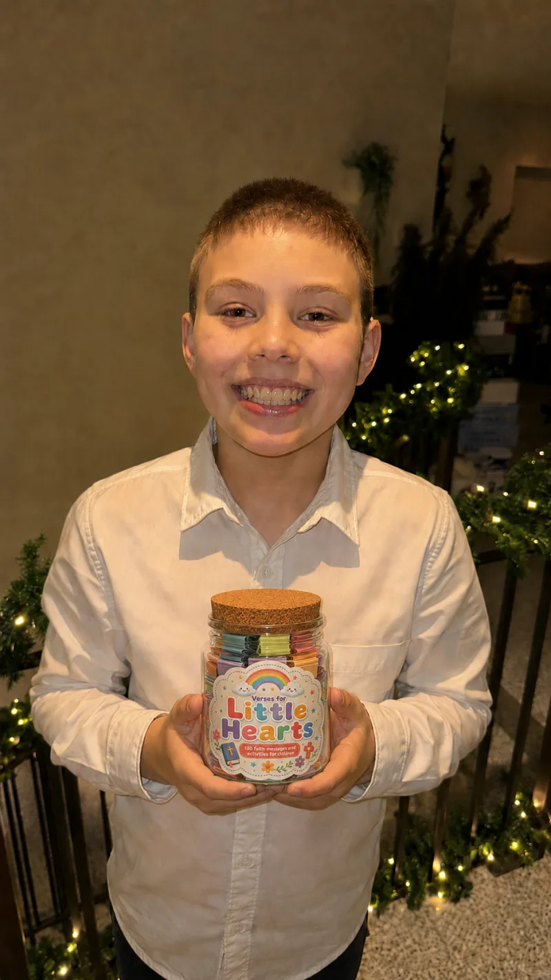 A child holding the Verses for Little Hearts jar